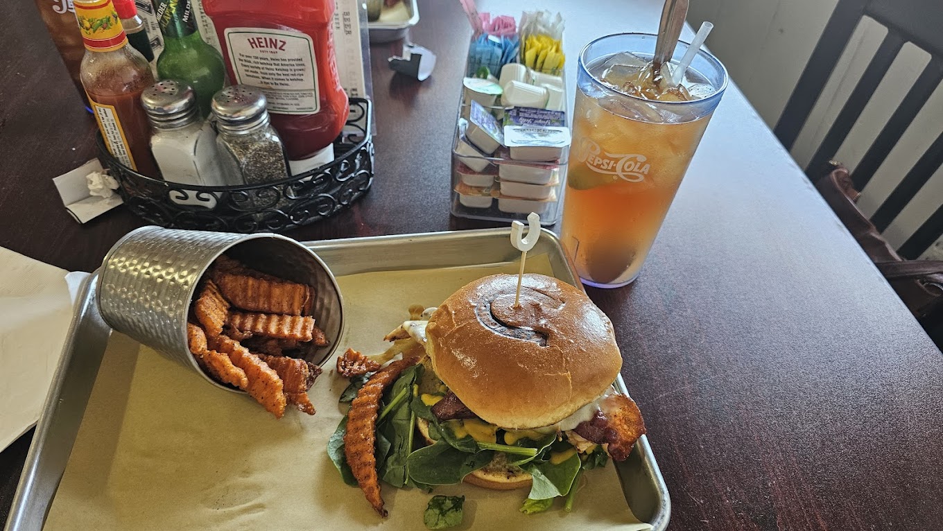 A burger, fries and a drink on the table